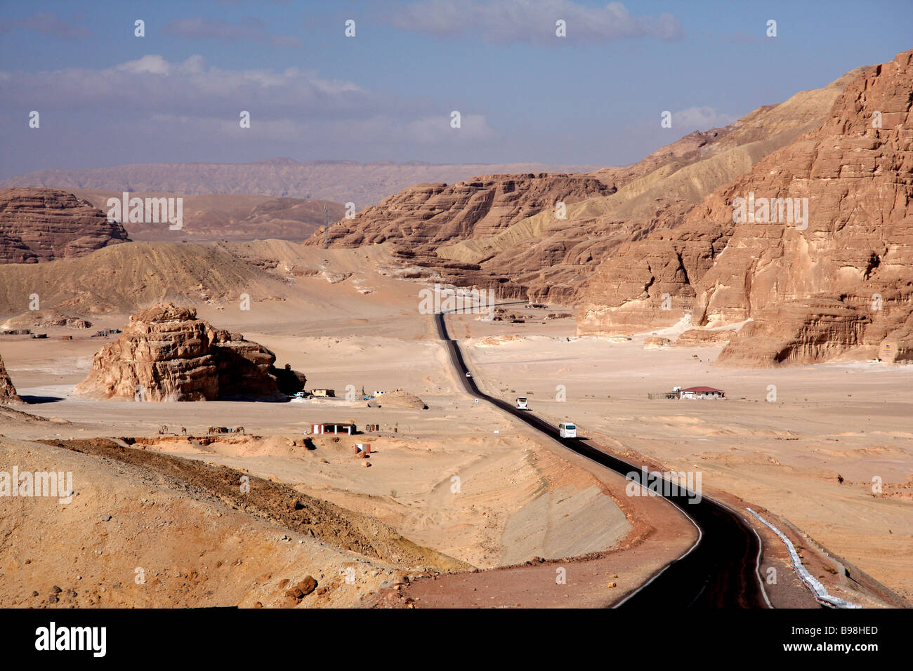 Desert road, mountains and Bedouin settlement between Sharm El Sheikh and St. Catherine's Monastery, South Sinai, Egypt Stock Photo
