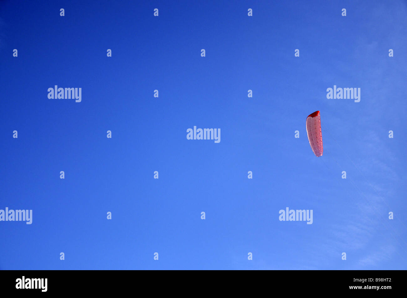Red power kite against blue sky Stock Photo