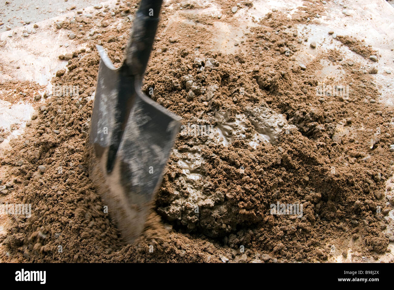 The correct measure of portland cement is mixed with ballast and water