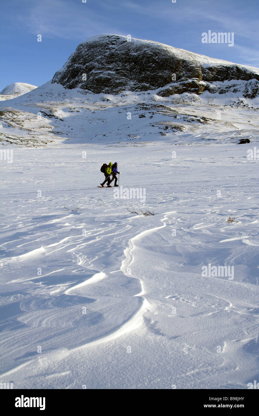 Two females with snowshoes walking in the Kungsleden, Swedish Lapplands, Sweden Stock Photo
