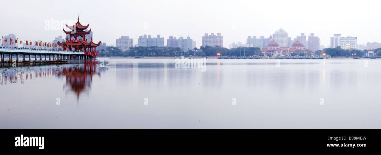 tranquil morning view of Spring and Autumn Pavilions  on Lotus Lake with Kaohsiung city in the distance. long exposure Stock Photo