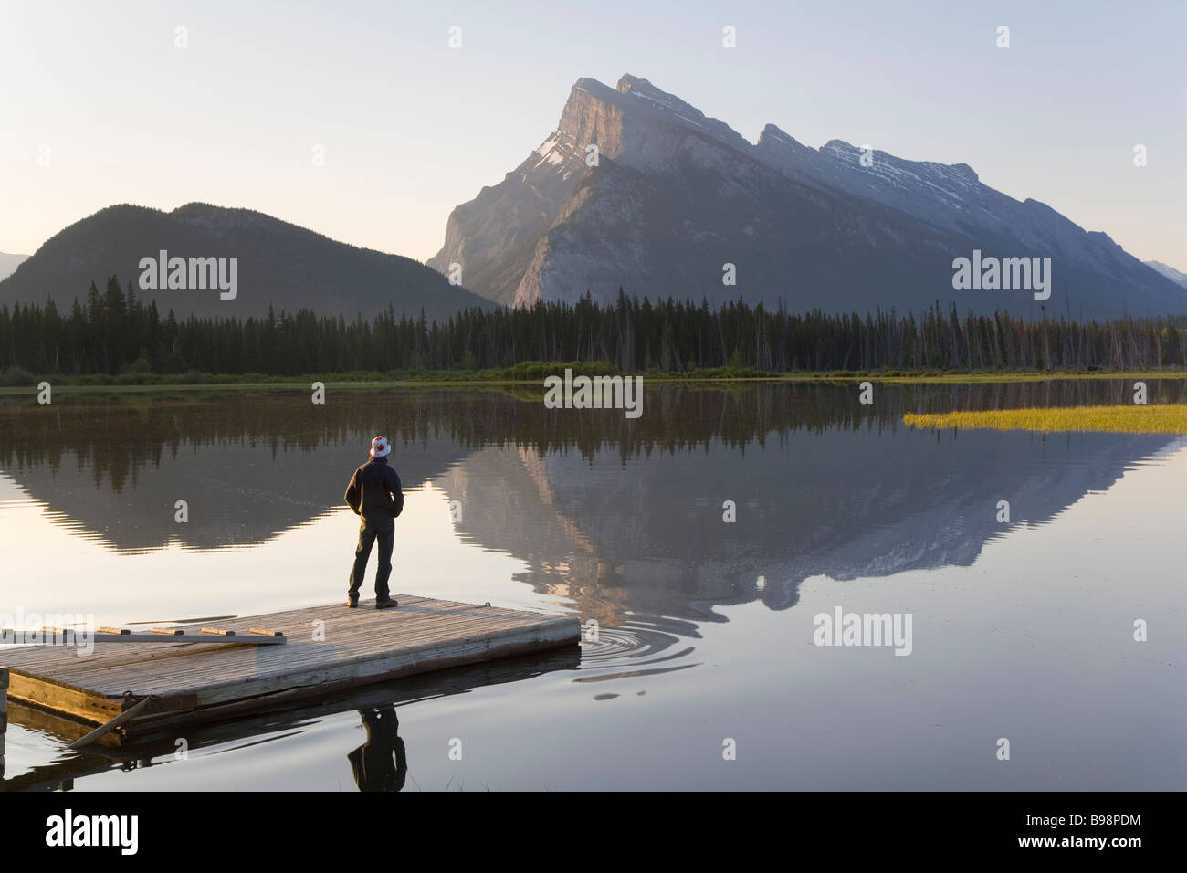 Mount Rundle, Vermillion Lake with man on pier, Banff National Park, Alberta, Canada Stock Photo