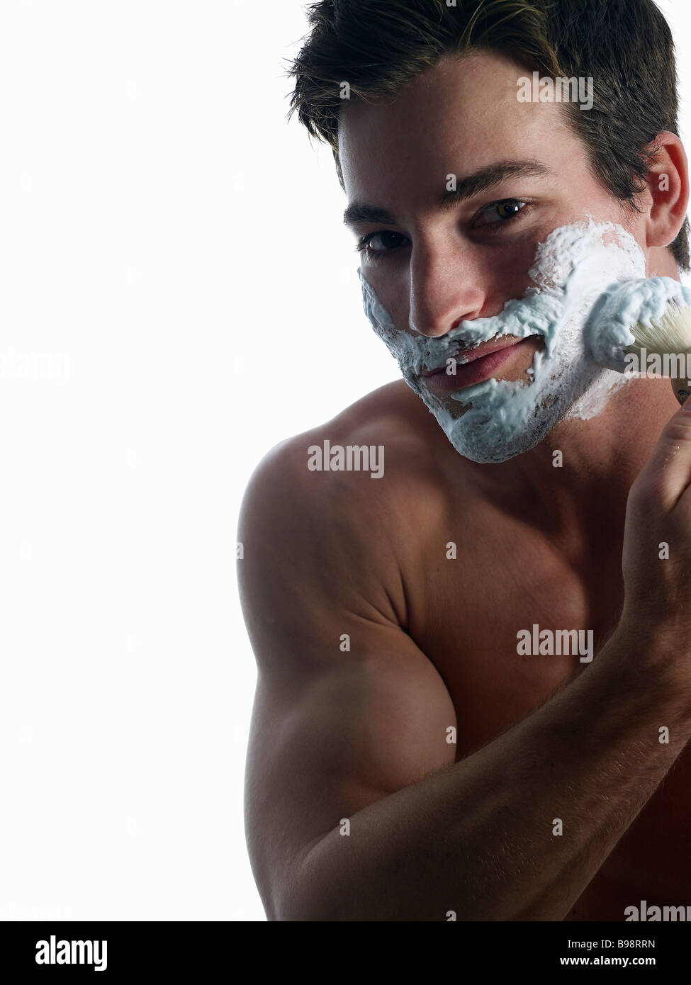 Man shaving face  with shaving foam Stock Photo