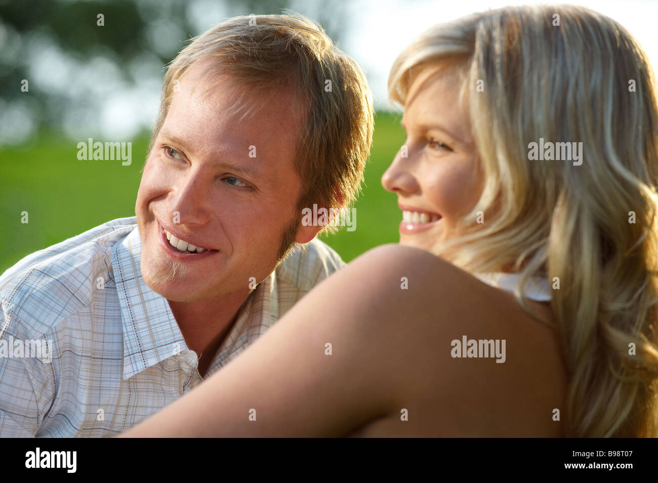 Couple lying in park Stock Photo