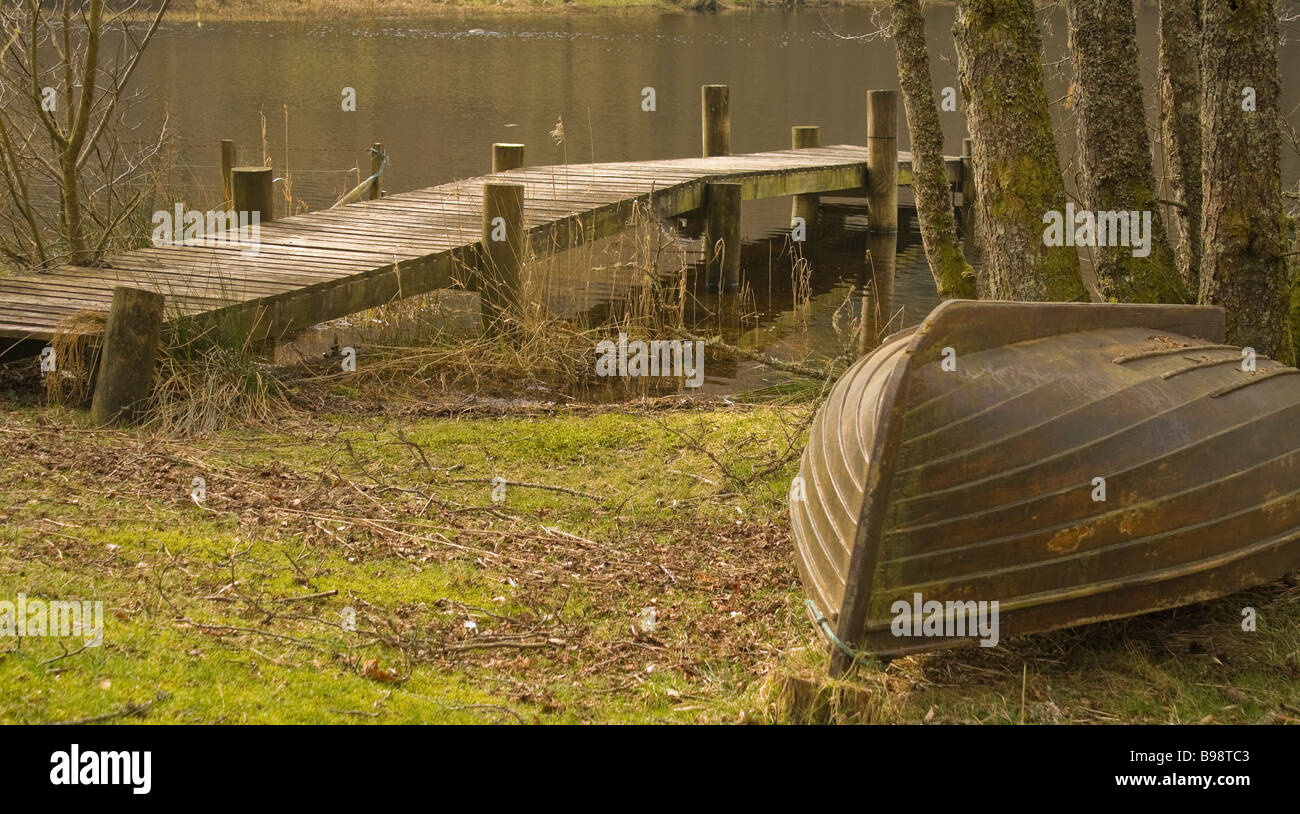 Upturned rowing boat beside a jetty on the loch Stock Photo - Alamy