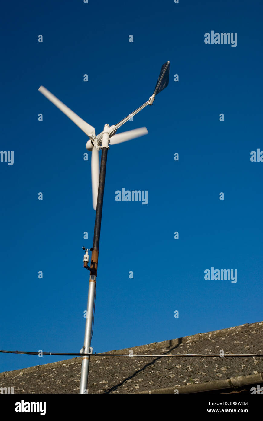 Domestic wind turbine against a bright blue sky Stock Photo - Alamy