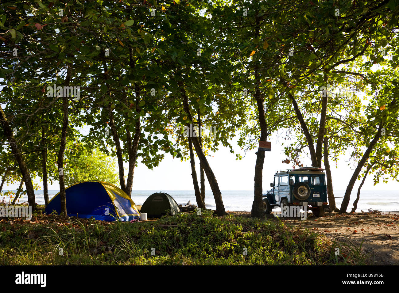 Camping tents and jeep along the beach in Dominical, Costa Rica. Stock Photo