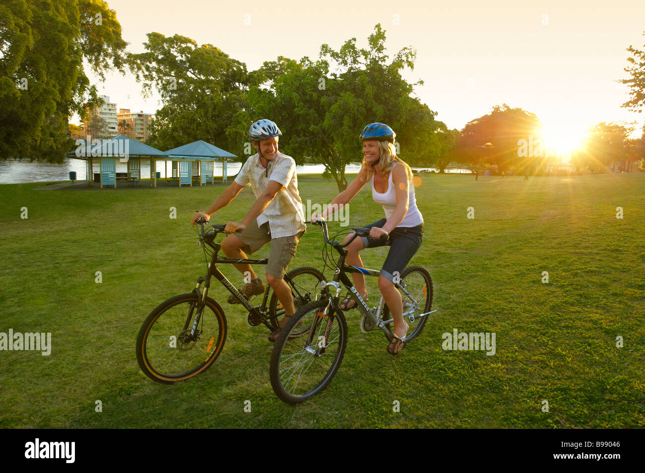 Couple riding bikes in the park Stock Photo