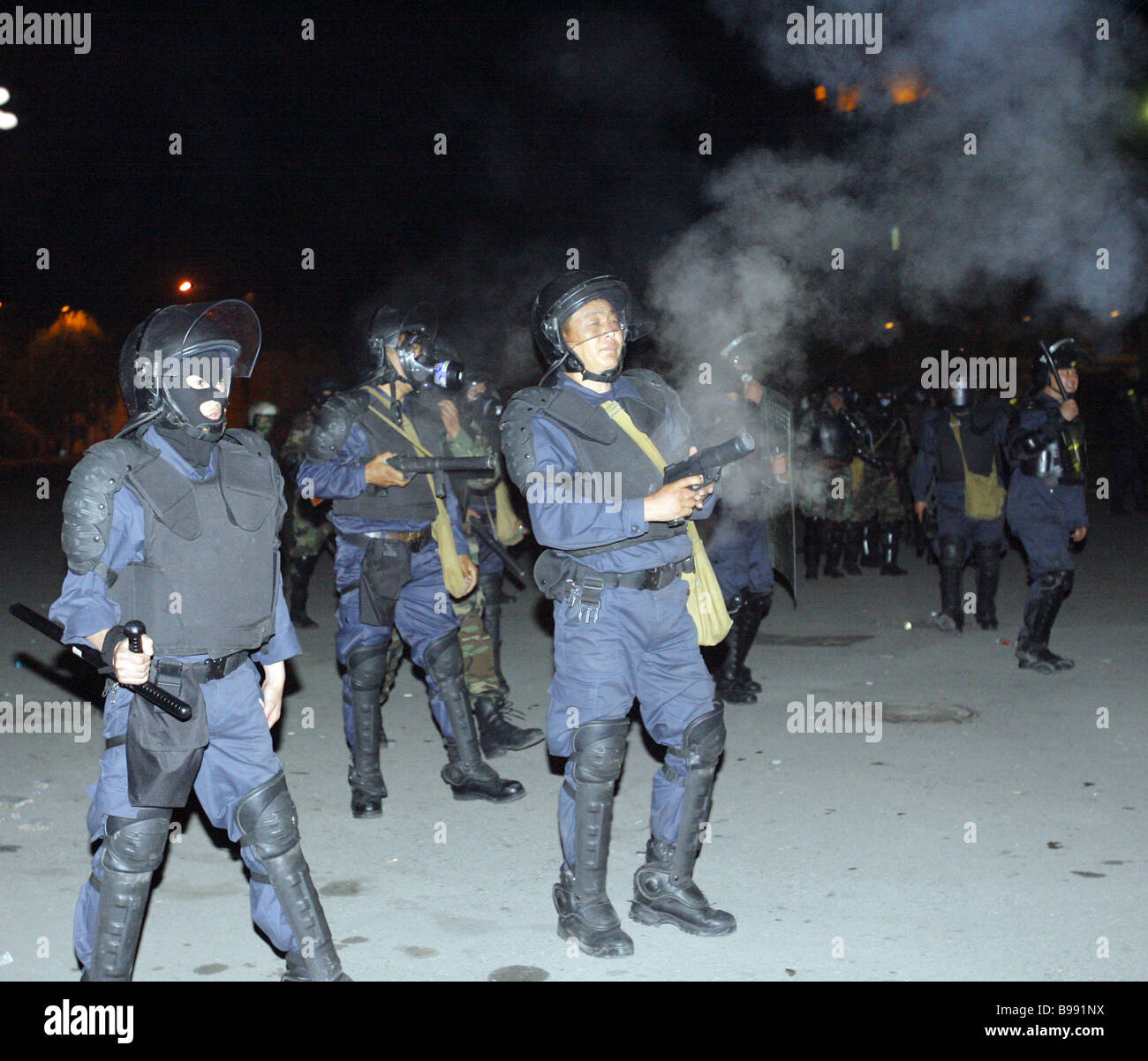 Riot police using tear gas and stun grenades to disperse an opposition ...