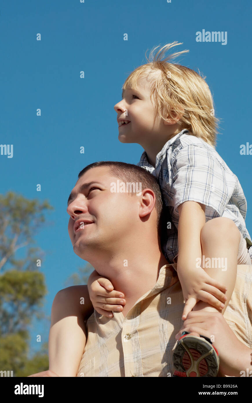 younger brother younger on shoulders at senior brother against the sky Stock Photo Alamy