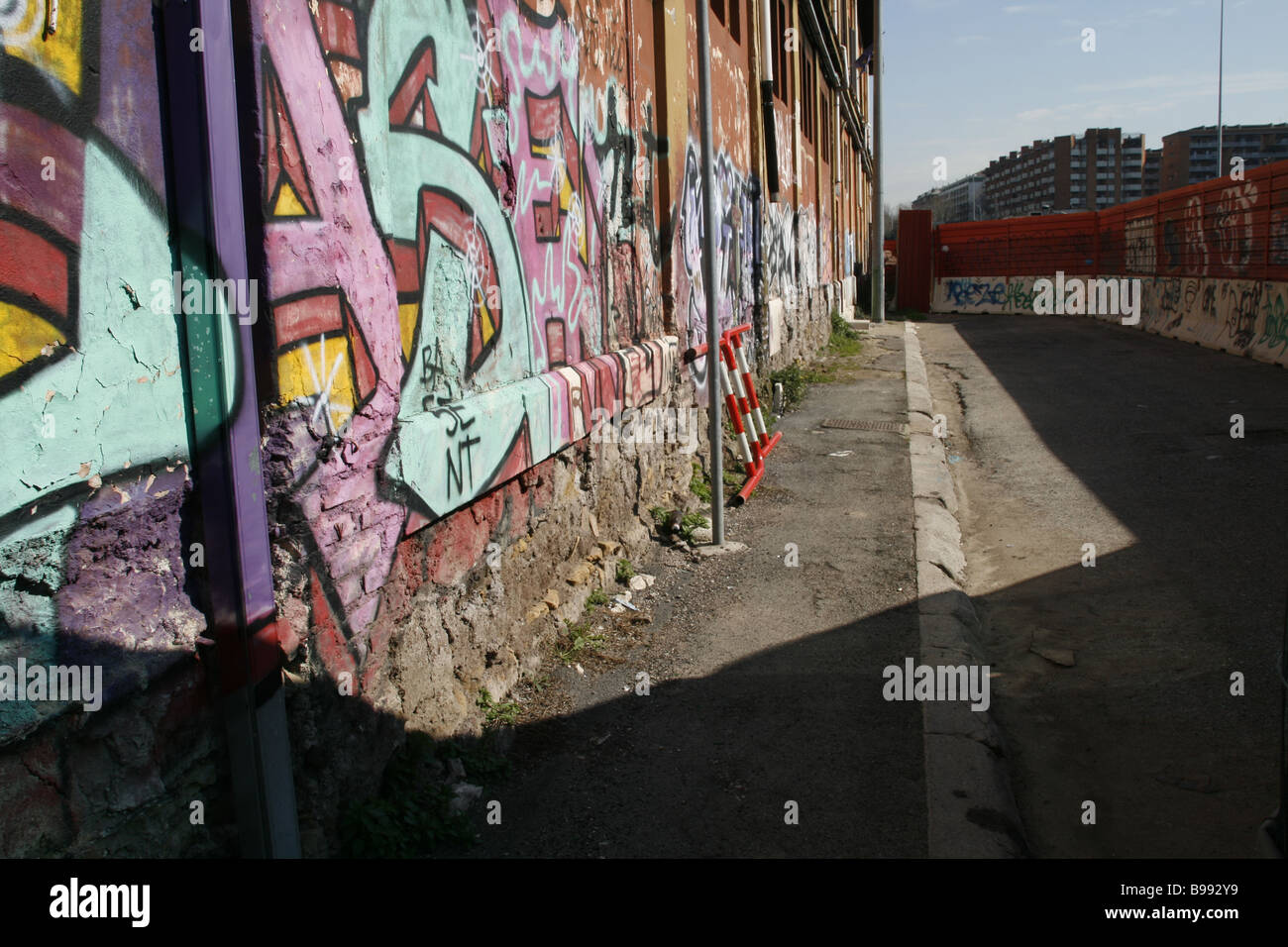 colourful urban graffiti on old wall surface in city street in sun outdoors Stock Photo