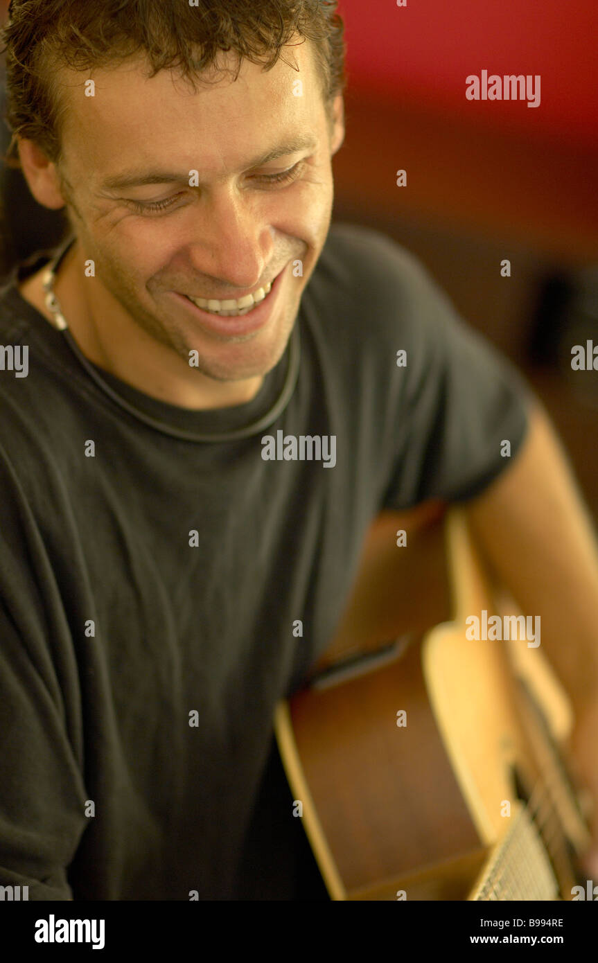 Young guy playing acousic guitar Stock Photo