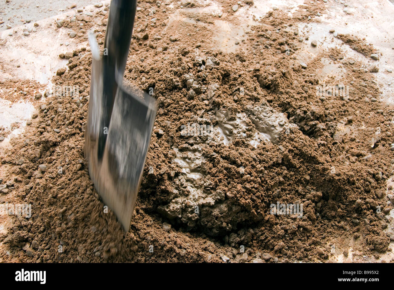 The correct measure of portland cement is mixed with ballast and water