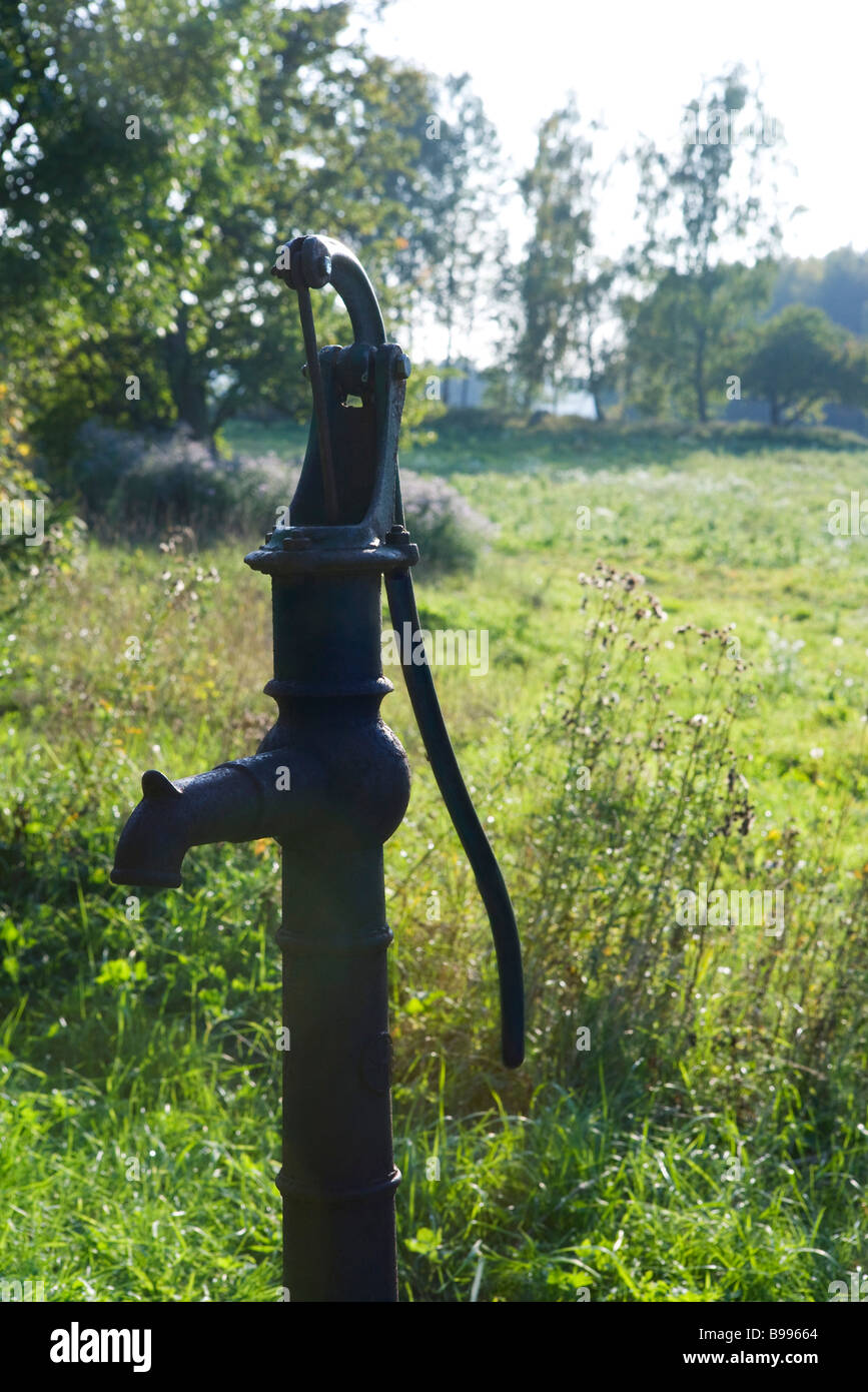 Oldfashioned water pump in sunny meadow Stock Photo Alamy