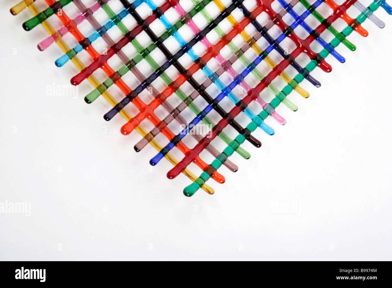 bold graphic mix of coloured stripes arranged in a lattice or laced pattern made in glass Stock Photo