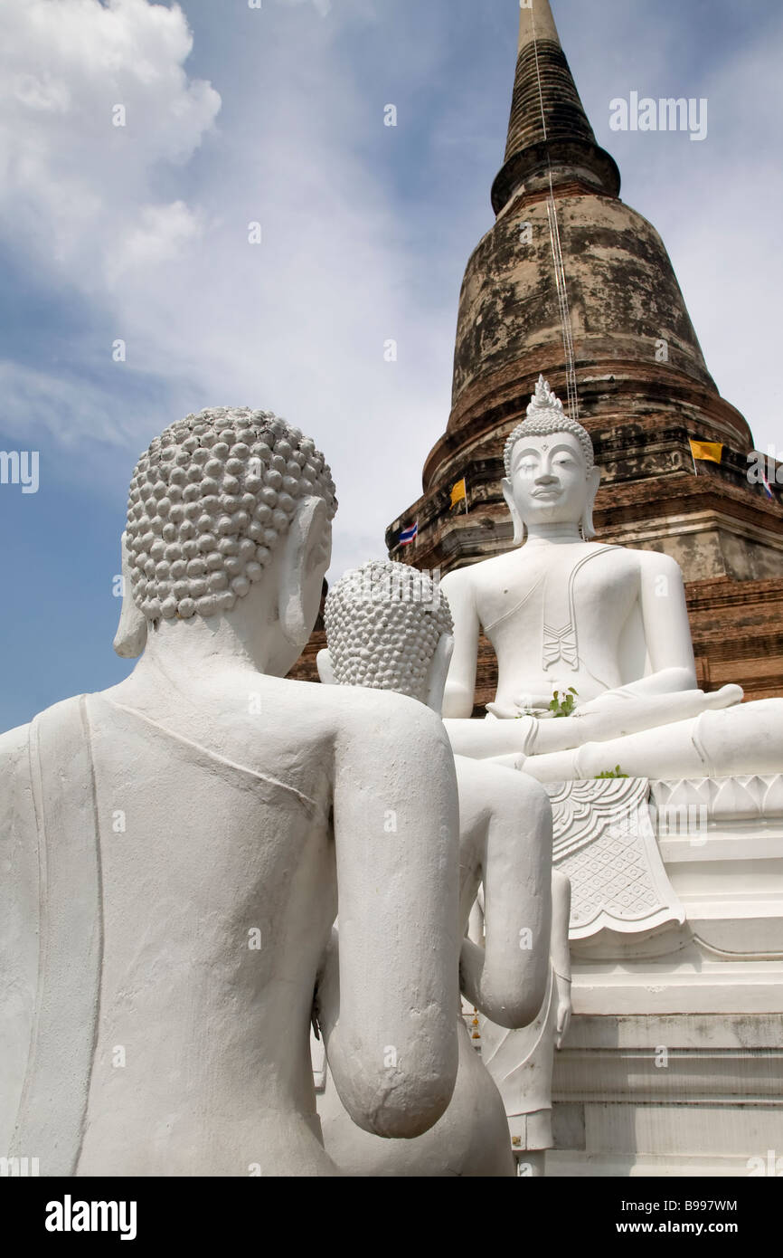 Buddha statues in Ayutthaya Thailand under a blue sky with fluffy white clouds Stock Photo