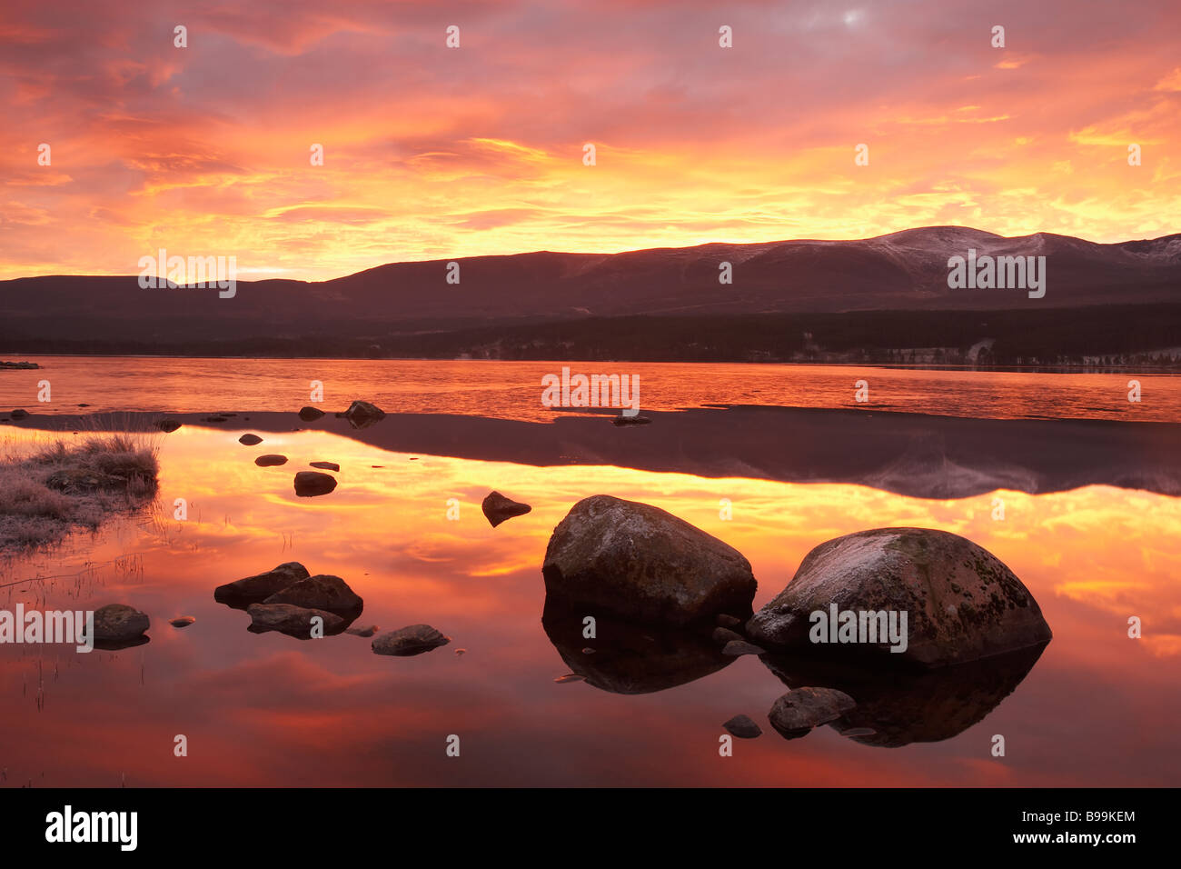 Loch Morlich and Cairngorm Mountains at dawn Stock Photo