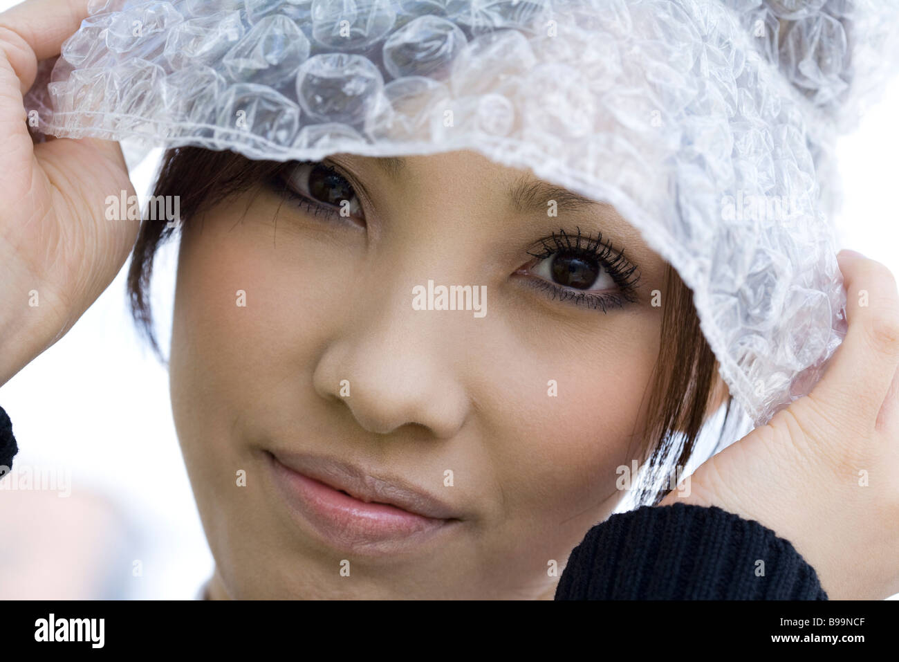 Female wearing hat made of bubble wrap, portrait Stock Photo Alamy
