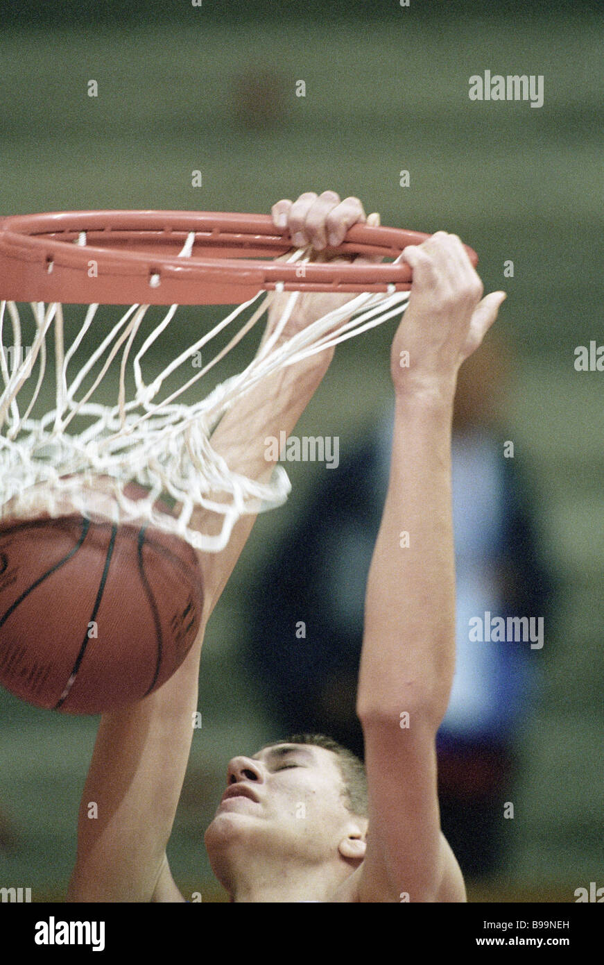 Participant in a basketball match throwing the ball into the basket