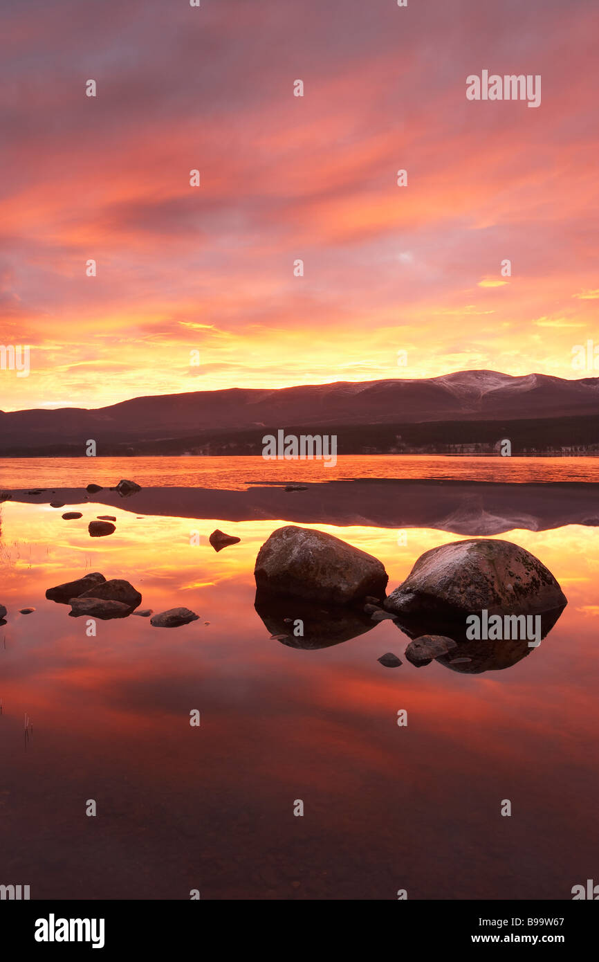 Loch Morlich and Cairngorm Mountains at dawn Stock Photo