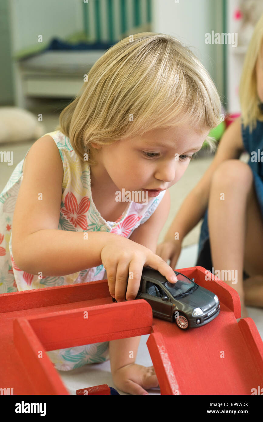 Little girl playing with toy car Stock Photo Alamy