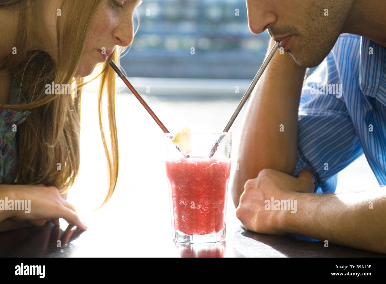 Couple sharing cool drink, cropped Stock Photo