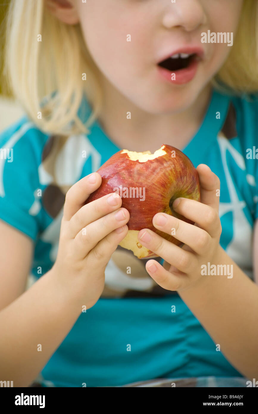 Little girl eating apple, cropped Stock Photo