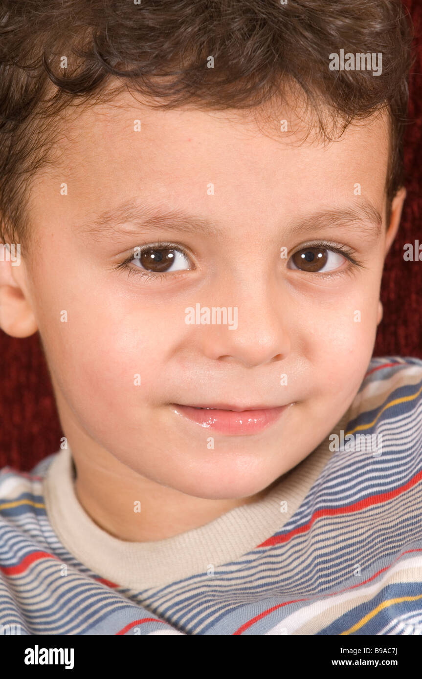 Cute little boy looking at the camera Stock Photo - Alamy