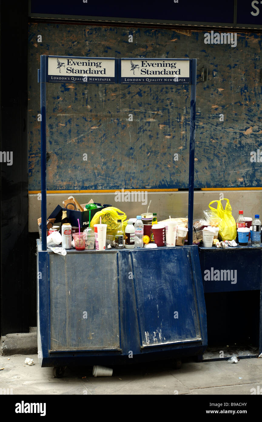 Rubbish laden Newspaper stall, outside St. Paul's tube station, London. Stock Photo