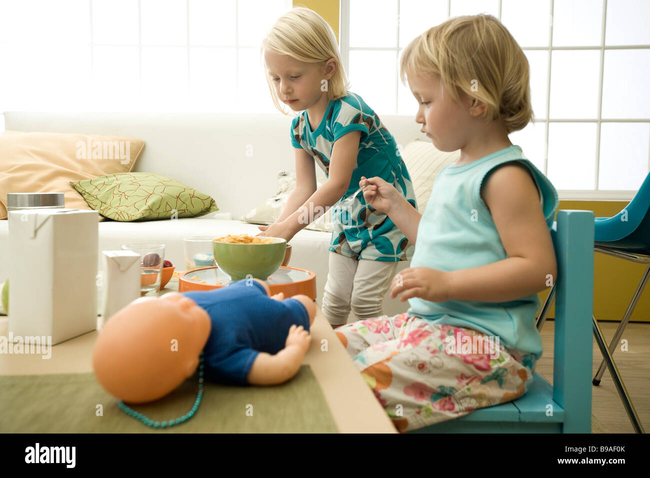 Little girls eating cereal at messy table Stock Photo Alamy