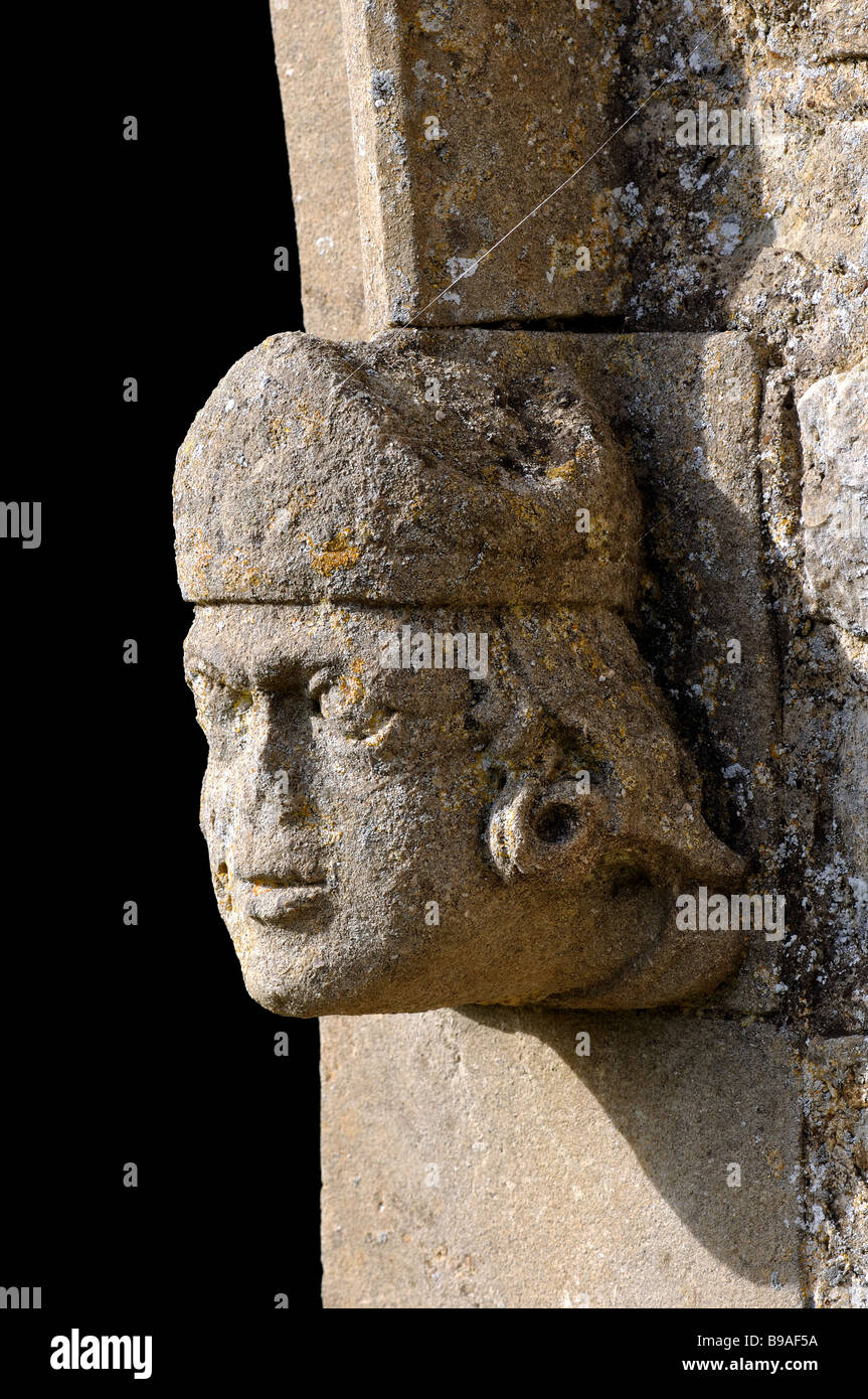 Stone head by doorway, St.Mary the Virgin Church, Hampton Poyle, Oxfordshire, England, UK Stock Photo