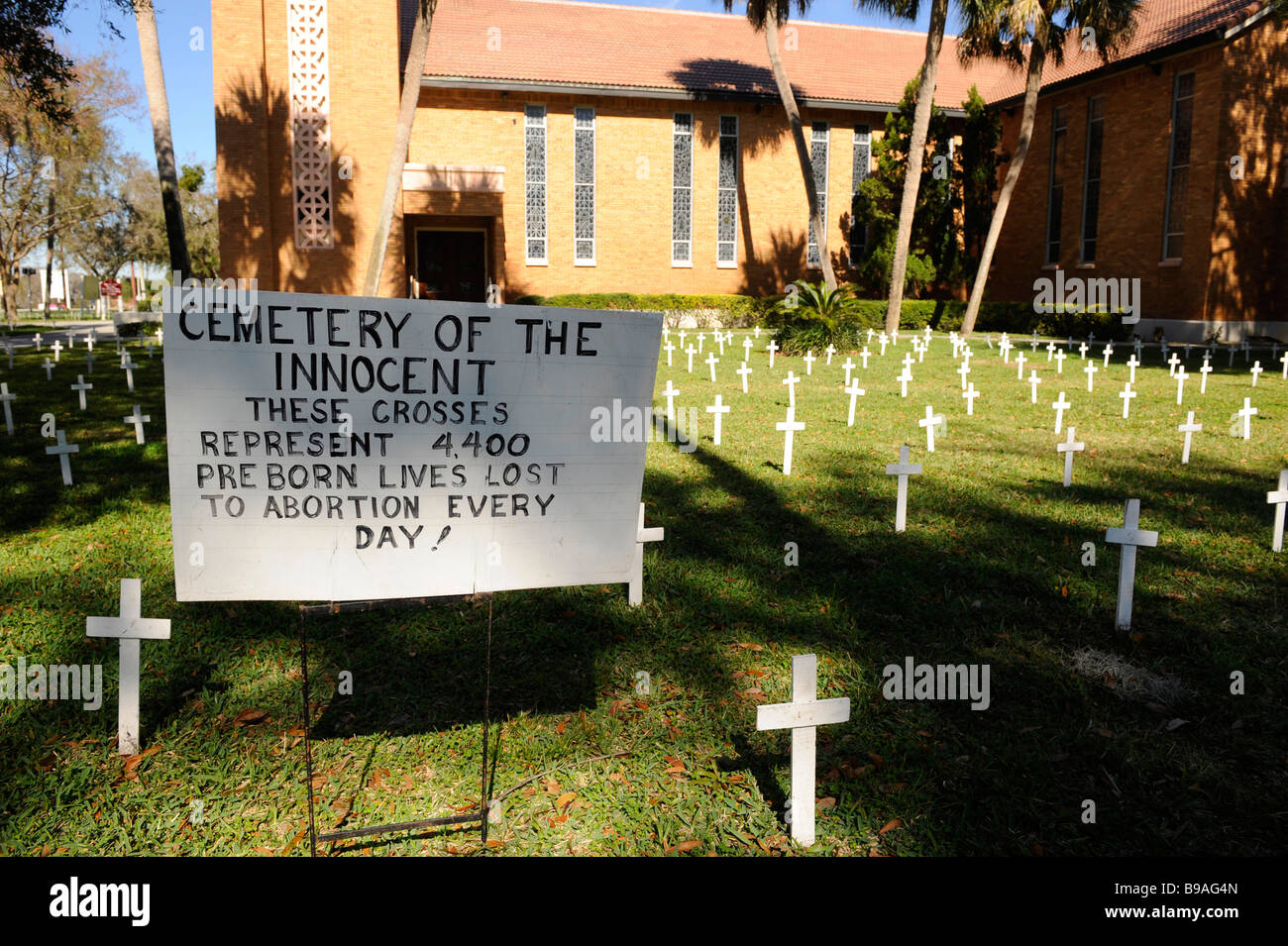 Crosses and sign on church lawn represent abortions performed Stock Photo