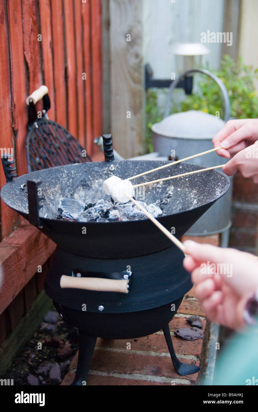 Cooking Marshmallows over a BBQ in the summer Stock Photo Alamy