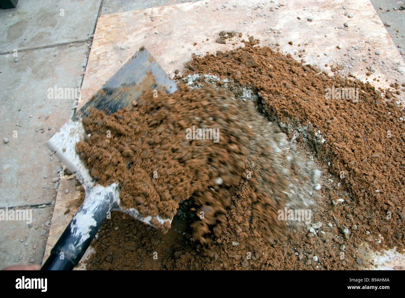 The correct measure of portland cement is mixed with ballast prior to