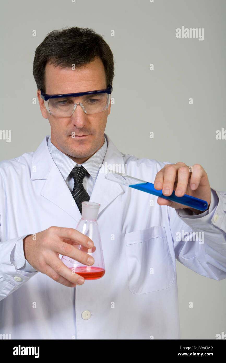Scientist mixing liquids Stock Photo