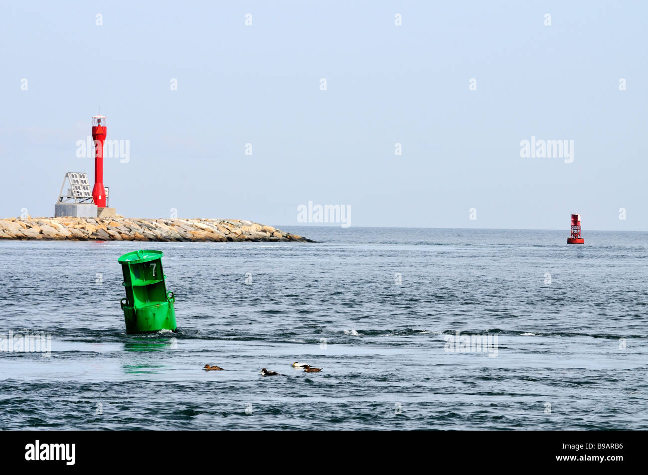 East entrance to the Cape Cod Canal in Sandwich with jetty, beacon, green and red navigational channel markers Stock Photo