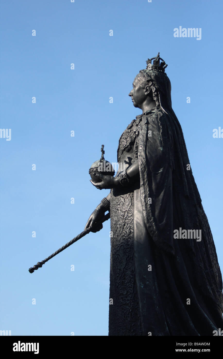 bronze statue of Queen Victoria was designed and executed by Sir Edgar Boehm. It was erected in 1887 in celebration of the queen Stock Photo