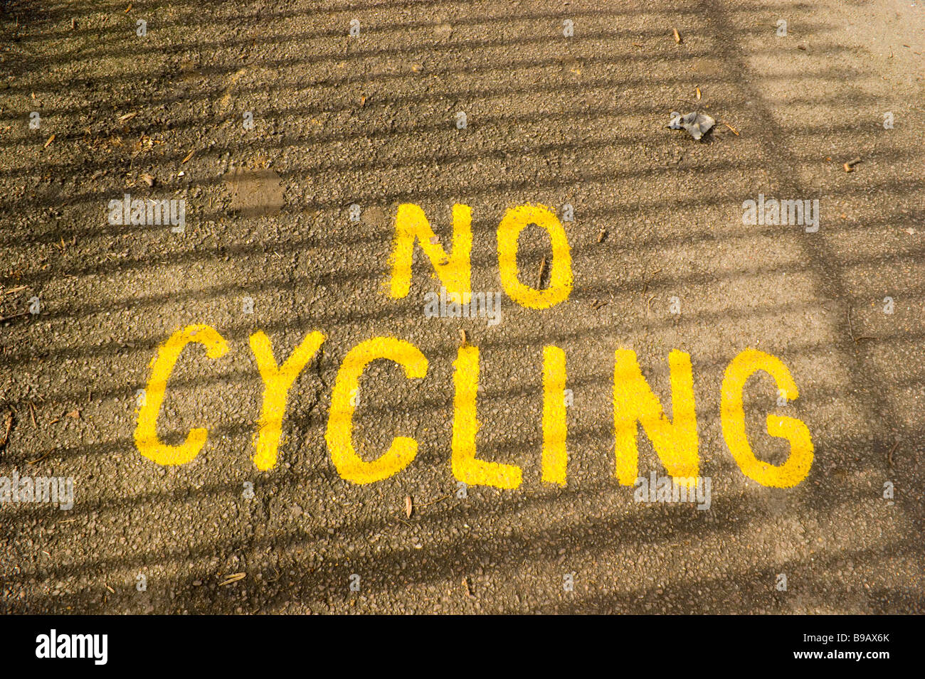 Shadow Impression Painted prohibitive message on path in Hampstead Heath. shadow ...