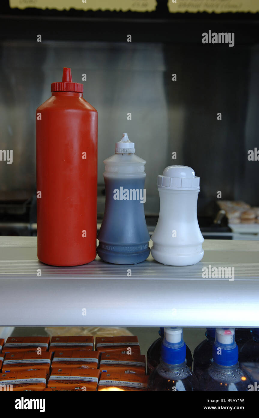 Ketchup vinegar and salt on the counter of a food stall cafe chip shop