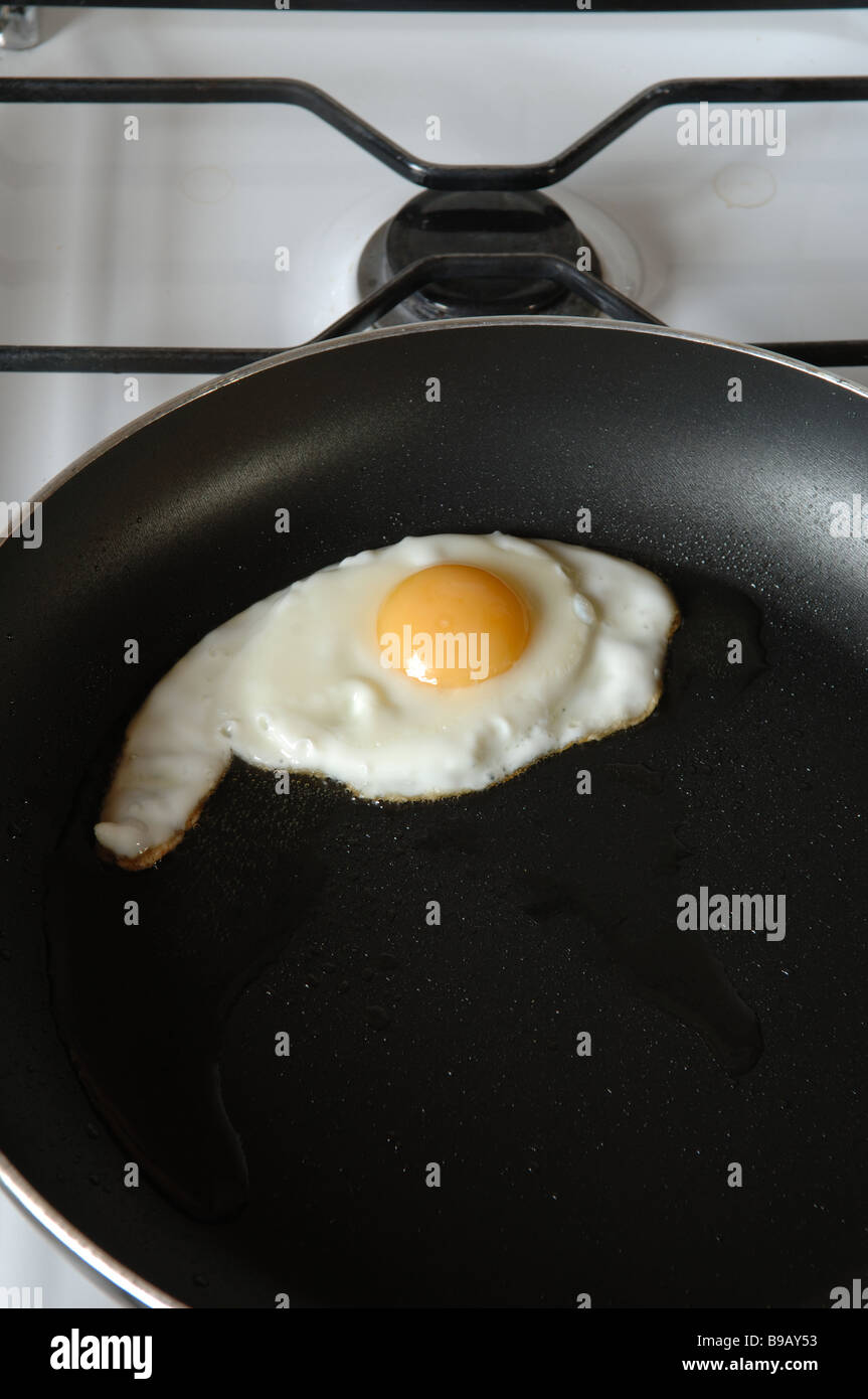 A fried egg in a nonstick frying pan on a gas stove Stock Photo Alamy
