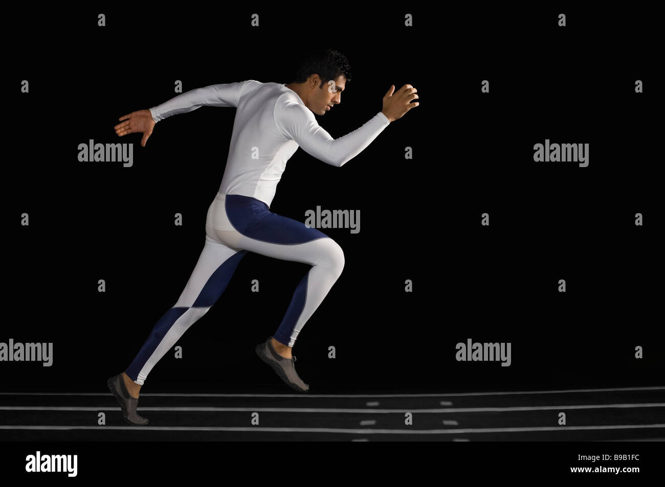 Male athlete running on track Stock Photo