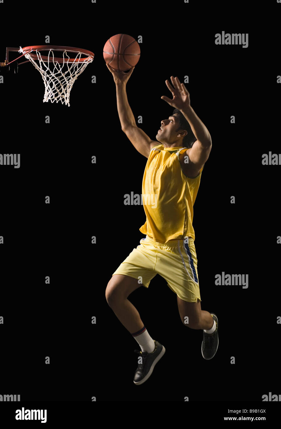 Basketball player shooting the basket Stock Photo