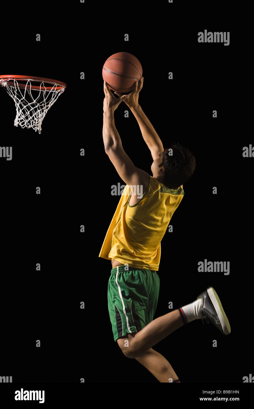 Basketball player shooting the basket Stock Photo