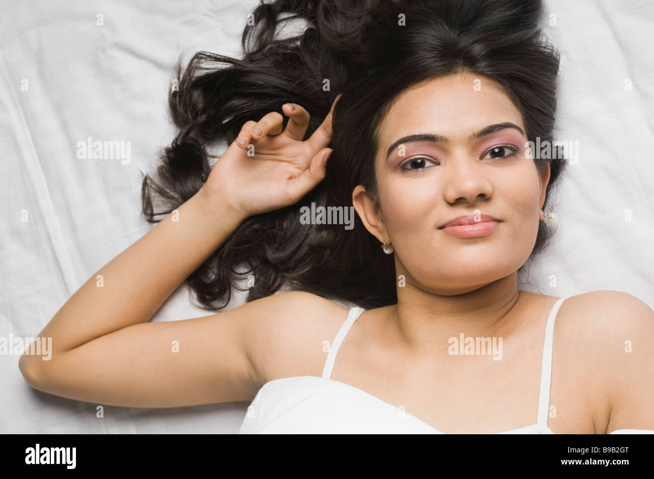 Woman relaxing on the bed Stock Photo - Alamy