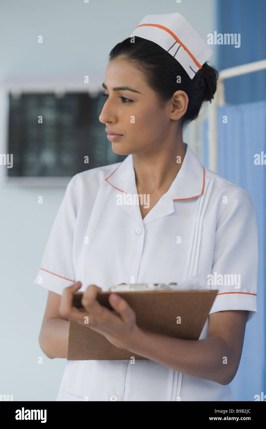Female nurse writing on a clipboard Stock Photo