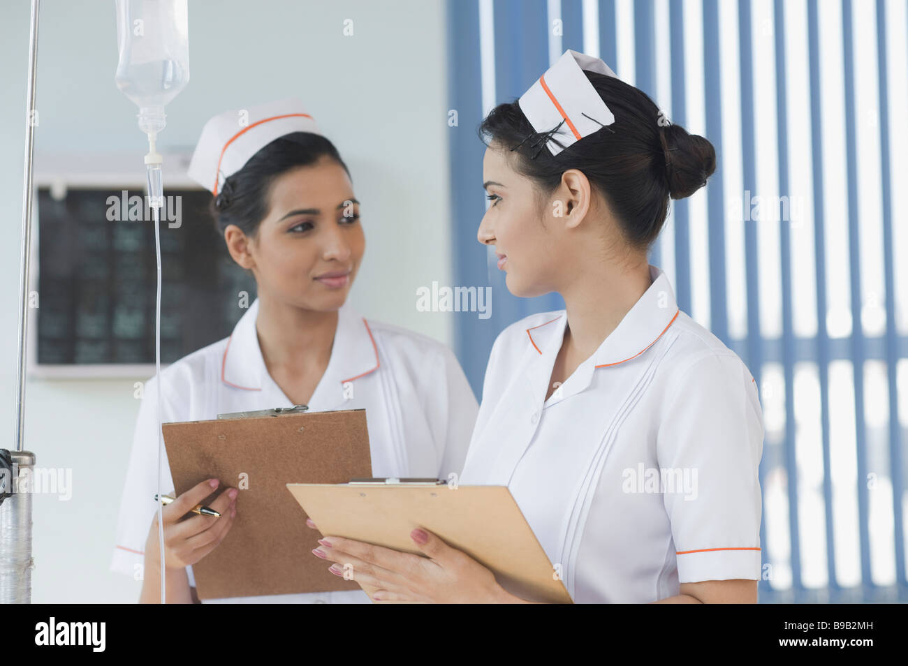 Two female nurses holding clipboards Stock Photo