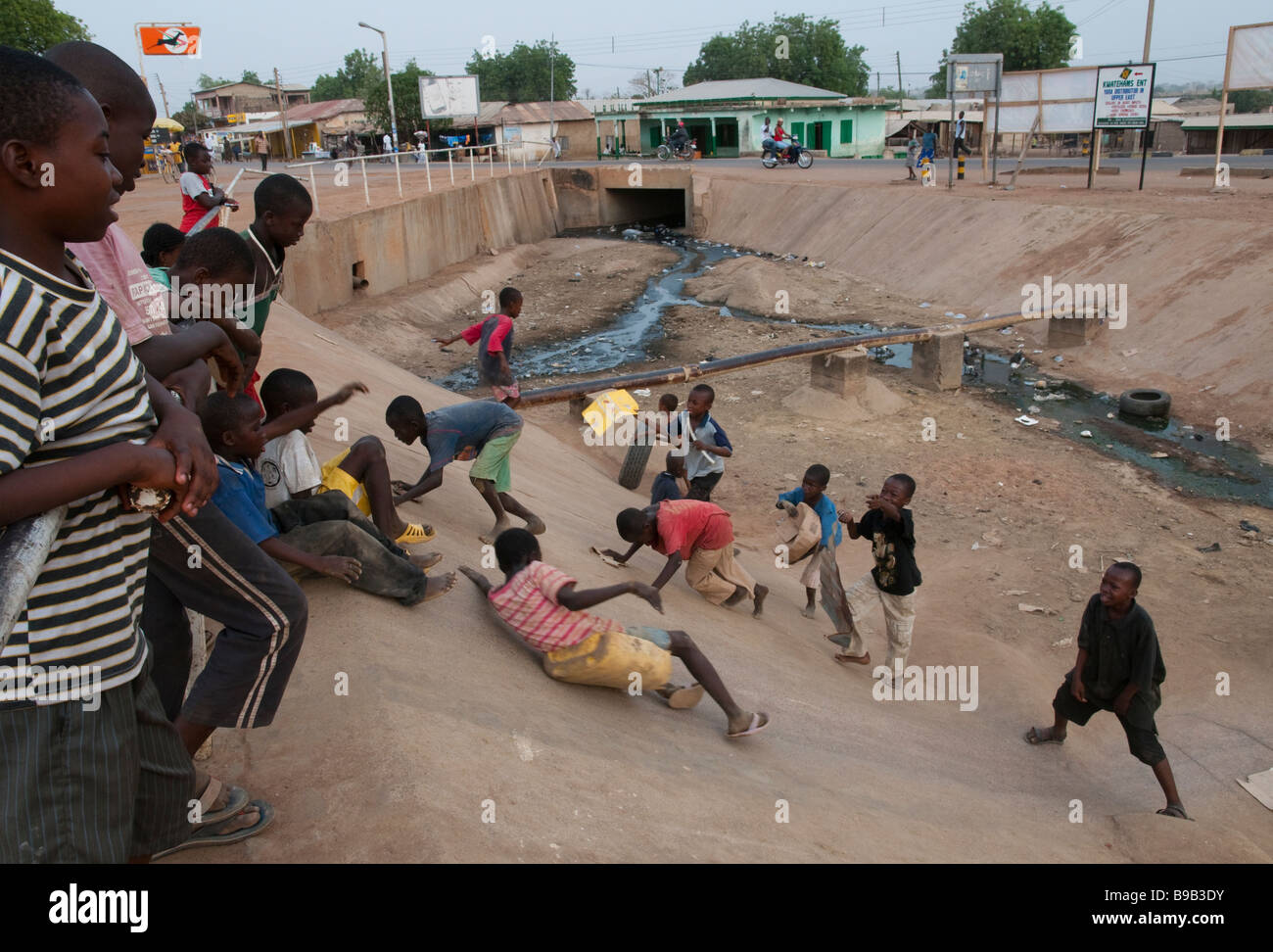 West Africa Ghana Bolgatanga Children playing near sewage stream Stock Photo