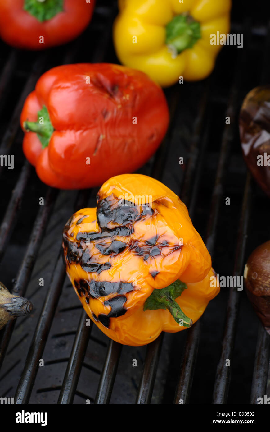 Yellow and red peppers roasted on grill Stock Photo Alamy
