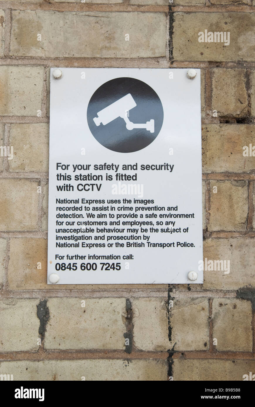 A sign at a railway station warning of cctv for safety and security Stock Photo