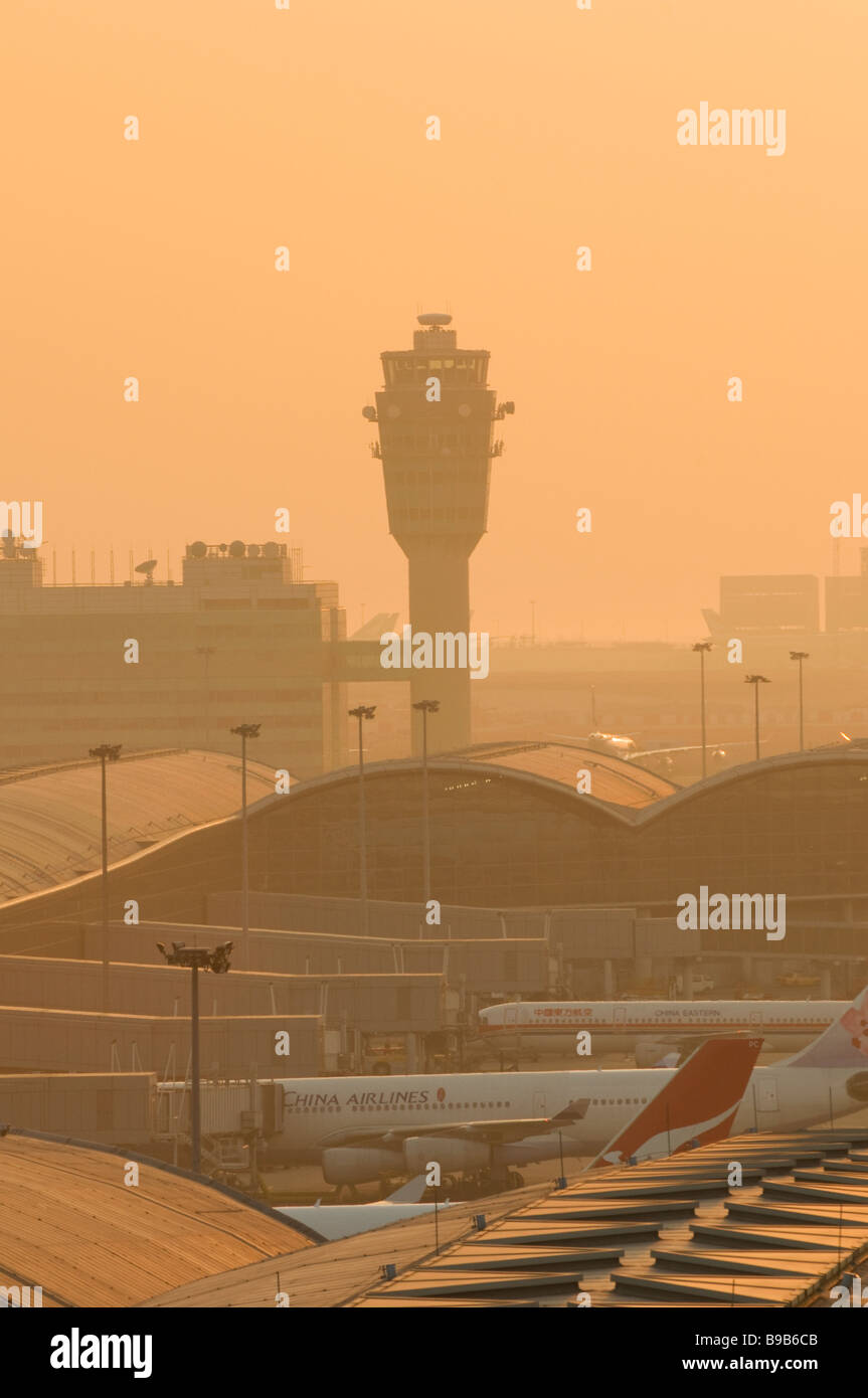 Smog shrouds Hong Kong Chek Lap Kok Airport at sunset. Stock Photo